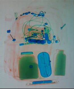 Baggage scan of black powder in a jar. (example)