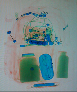 Baggage scan of black powder in a jar. (example)